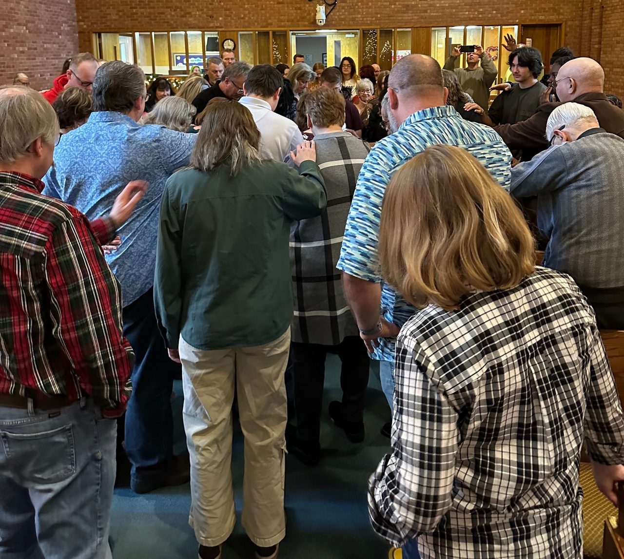 Congregation gathered in prayer at God's Grace Church