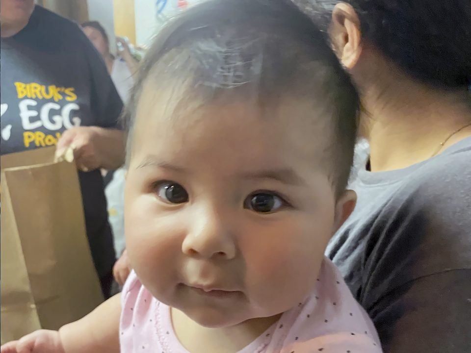 Close-up of a smiling baby at Kid's Kloset
